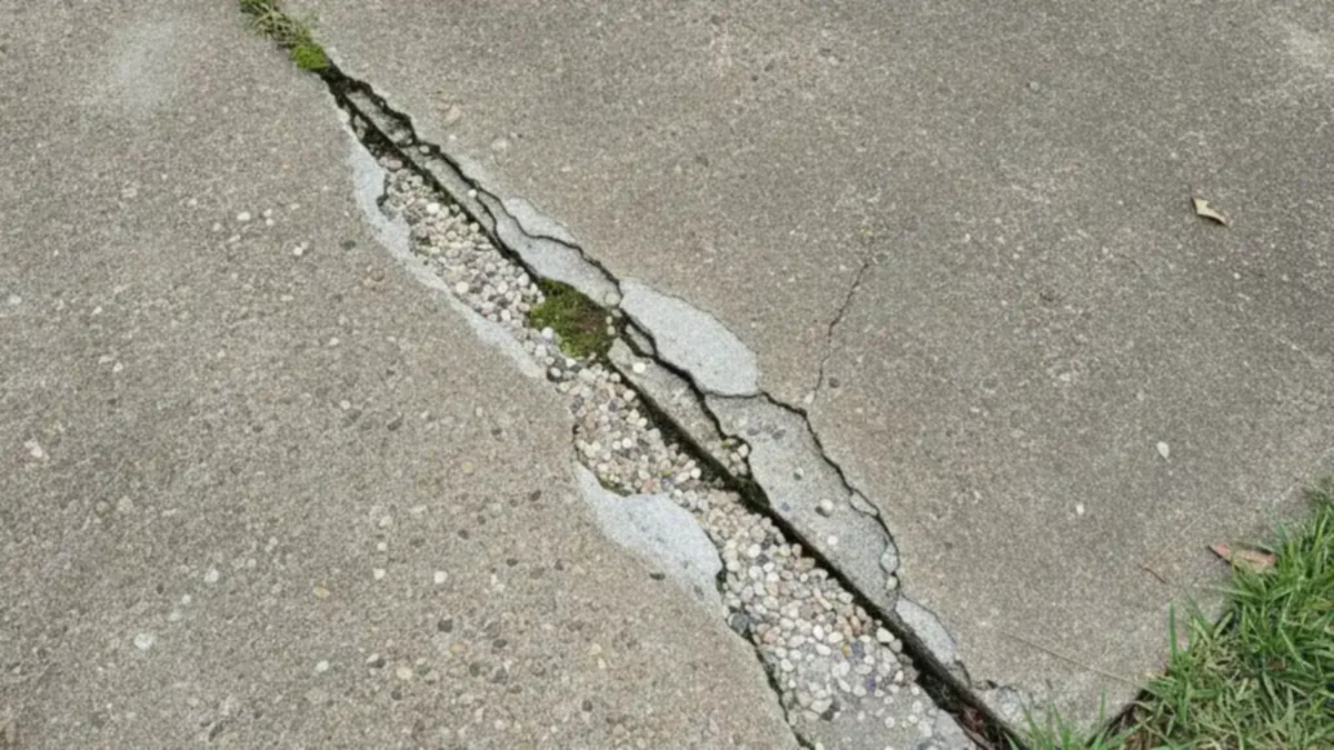 Cracked residential driveway showing uneven concrete in Pearl